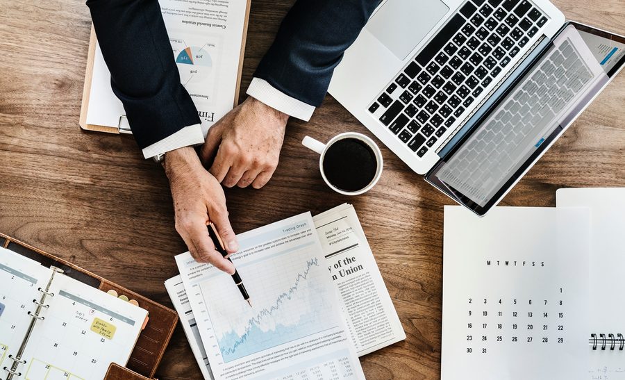 Financial advisor reviewing charts and reports at a desk